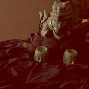 Buddha statue with oil burners